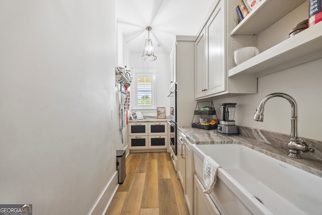 639 Frank Crook Rd, Canon, GA 30520 - kitchen with open shelves, light countertops, light wood-style flooring, and hanging light fixtures