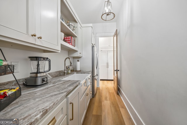639 Frank Crook Rd, Canon, GA 30520 - kitchen featuring freestanding refrigerator, light wood-style flooring, white cabinets, and open shelves