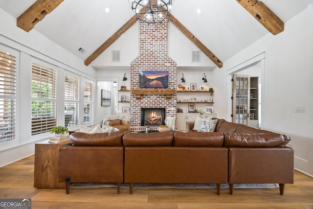 639 Frank Crook Rd, Canon, GA 30520 - living room featuring beamed ceiling, a fireplace, light wood-type flooring, and high vaulted ceiling