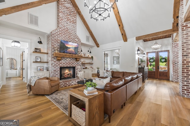 639 Frank Crook Rd, Canon, GA 30520 - living room featuring a chandelier, high vaulted ceiling, light wood-style floors, beam ceiling, and a brick fireplace