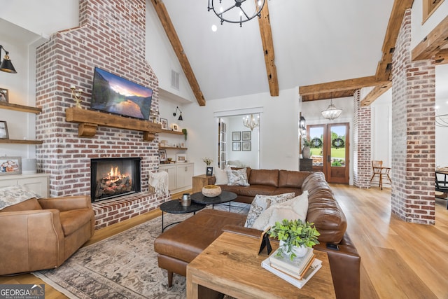 639 Frank Crook Rd, Canon, GA 30520 - living room with wood finished floors, a fireplace, a chandelier, beam ceiling, and high vaulted ceiling