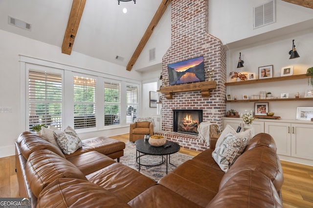 639 Frank Crook Rd, Canon, GA 30520 - living room featuring a brick fireplace, light wood-style flooring, beamed ceiling, and high vaulted ceiling