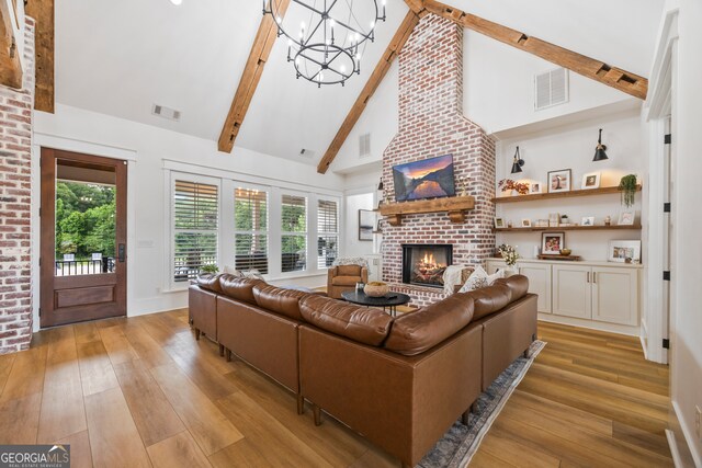 639 Frank Crook Rd, Canon, GA 30520 - living area featuring a chandelier, a fireplace, beamed ceiling, light wood-type flooring, and high vaulted ceiling