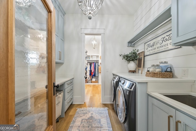 639 Frank Crook Rd, Canon, GA 30520 - laundry room featuring cabinet space, a chandelier, washing machine and dryer, and light wood-style floors