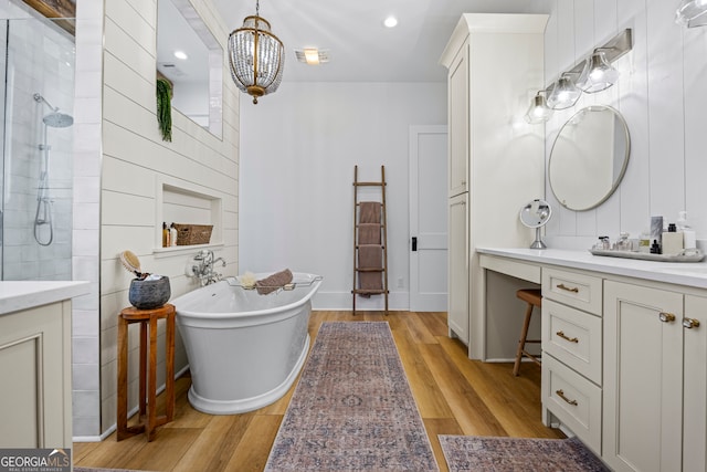 639 Frank Crook Rd, Canon, GA 30520 - full bathroom featuring vanity, a tile shower, a freestanding tub, wood finished floors, and recessed lighting