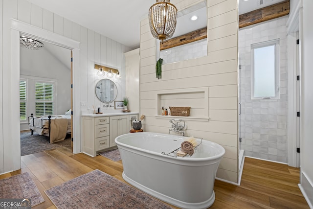 639 Frank Crook Rd, Canon, GA 30520 - full bathroom with a chandelier, hardwood / wood-style flooring, a soaking tub, vanity, and wood walls