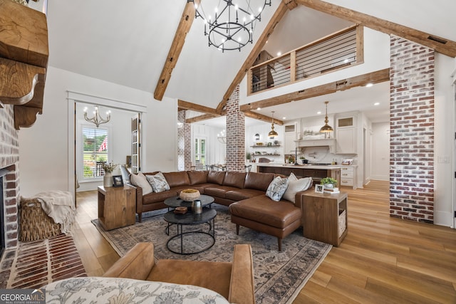 639 Frank Crook Rd, Canon, GA 30520 - living area with a chandelier, high vaulted ceiling, light wood-type flooring, beamed ceiling, and a fireplace