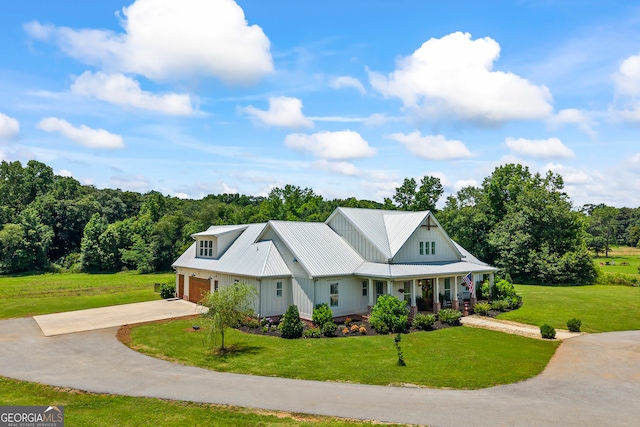 639 Frank Crook Rd, Canon, GA 30520 - modern inspired farmhouse featuring driveway, covered porch, a front lawn, board and batten siding, and a garage