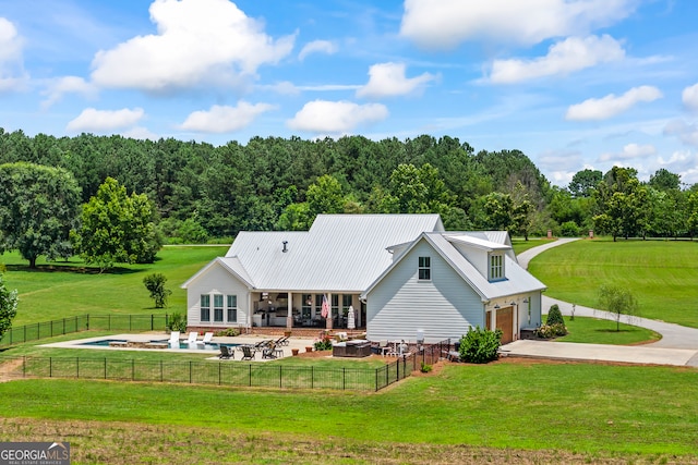 639 Frank Crook Rd, Canon, GA 30520 - back of property featuring a garage, driveway, a patio, a metal roof, and a fenced backyard