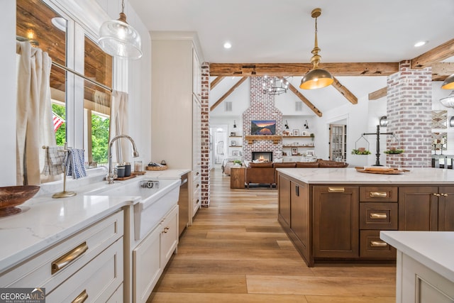 639 Frank Crook Rd, Canon, GA 30520 - kitchen featuring a fireplace, light wood-type flooring, decorative light fixtures, white cabinetry, and light stone counters