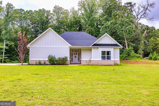 40 Westbrook Rd, Carrollton, GA 30116 - view of front of house with board and batten siding, a front lawn, brick siding, and view of wooded area