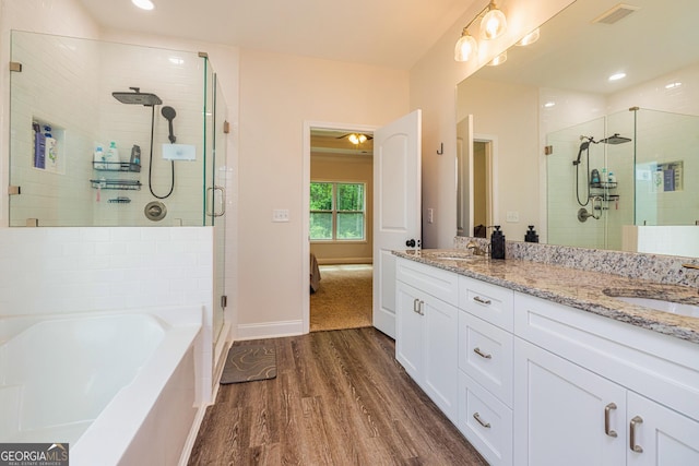 40 Westbrook Rd, Carrollton, GA 30116 - full bath featuring wood finished floors, a stall shower, double vanity, a bath, and recessed lighting