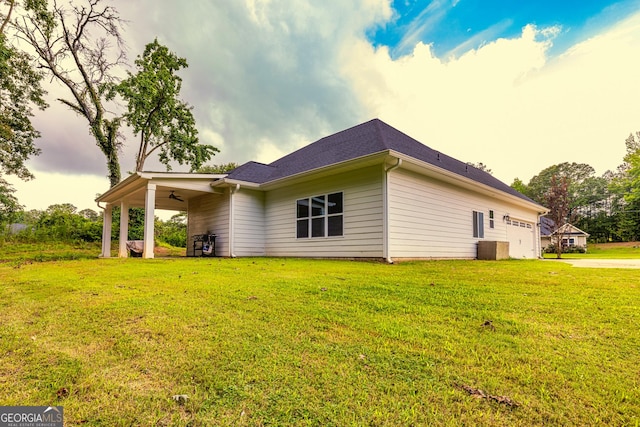 40 Westbrook Rd, Carrollton, GA 30116 - view of side of home featuring ceiling fan, a lawn, driveway, and an attached garage