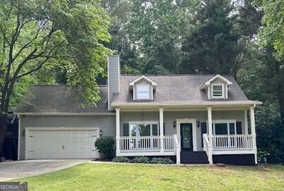 852 Georgetowne Dr, Winder, GA 30680 - cape cod home featuring a garage, concrete driveway, a front yard, a porch, and a chimney