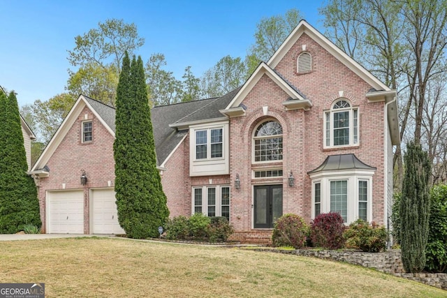 3887 Hickory Manor Dr, Suwanee, GA 30024 - colonial house with brick siding, a front lawn, and concrete driveway