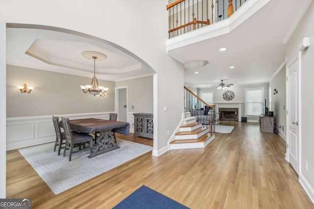 3887 Hickory Manor Dr, Suwanee, GA 30024 - entrance foyer with stairway, arched walkways, wood finished floors, a chandelier, and a fireplace