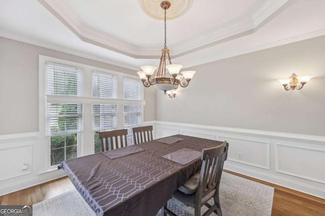 3887 Hickory Manor Dr, Suwanee, GA 30024 - dining area with a tray ceiling, a chandelier, crown molding, wainscoting, and a decorative wall