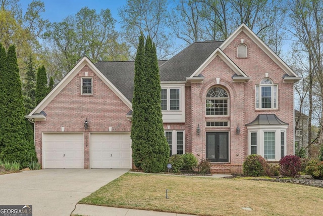3887 Hickory Manor Dr, Suwanee, GA 30024 - view of front facade featuring concrete driveway, brick siding, a front yard, and french doors