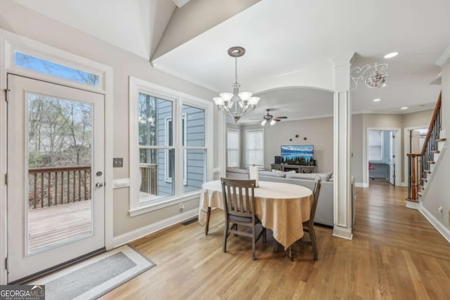 3887 Hickory Manor Dr, Suwanee, GA 30024 - dining area featuring a chandelier, a ceiling fan, light wood-style floors, healthy amount of natural light, and crown molding