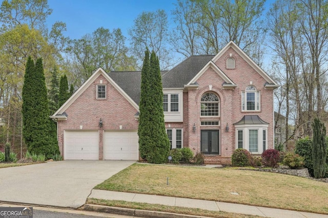 3887 Hickory Manor Dr, Suwanee, GA 30024 - view of front facade featuring brick siding, driveway, a front yard, and an attached garage