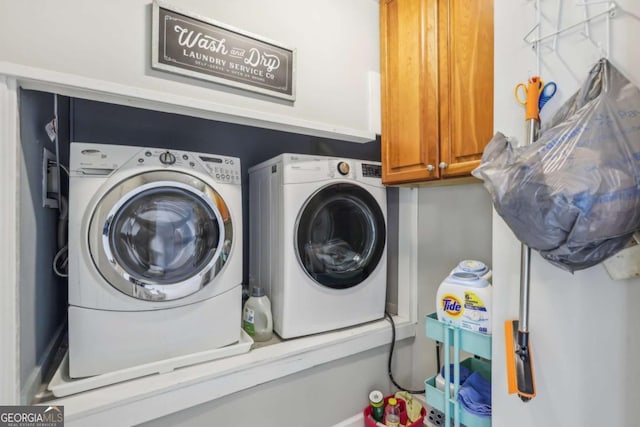 3887 Hickory Manor Dr, Suwanee, GA 30024 - laundry area featuring washer and dryer and cabinet space