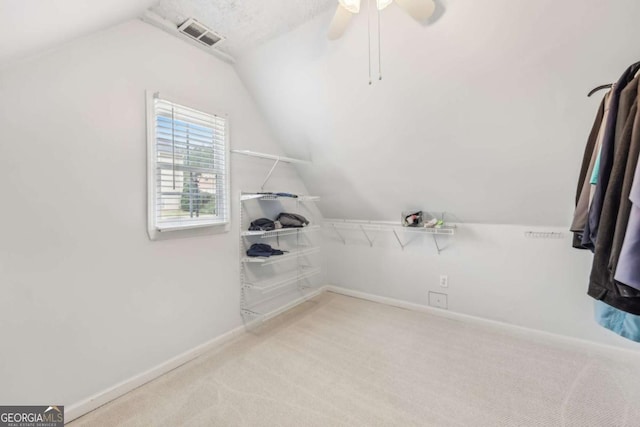 3887 Hickory Manor Dr, Suwanee, GA 30024 - spacious closet with lofted ceiling, carpet flooring, and a ceiling fan