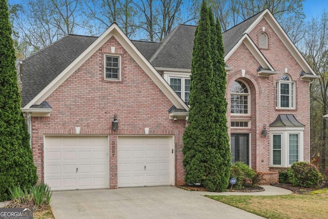 3887 Hickory Manor Dr, Suwanee, GA 30024 - traditional-style home featuring concrete driveway, brick siding, a shingled roof, and a garage