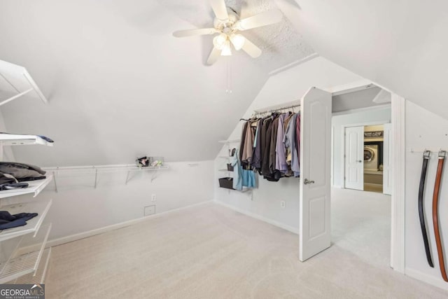 3887 Hickory Manor Dr, Suwanee, GA 30024 - walk in closet featuring lofted ceiling, washer / dryer, a ceiling fan, and carpet