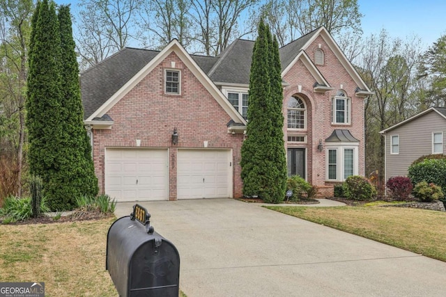 3887 Hickory Manor Dr, Suwanee, GA 30024 - traditional-style home with concrete driveway, brick siding, and a front yard