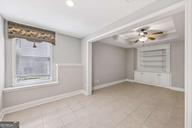 3887 Hickory Manor Dr, Suwanee, GA 30024 - spare room with a raised ceiling, built in features, light tile patterned floors, and ceiling fan