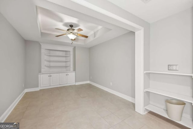 3887 Hickory Manor Dr, Suwanee, GA 30024 - unfurnished room featuring built in features, a raised ceiling, ceiling fan, and light tile patterned floors