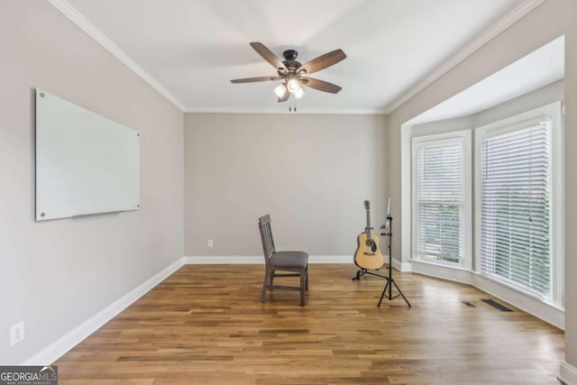 3887 Hickory Manor Dr, Suwanee, GA 30024 - sitting room with wood finished floors, ceiling fan, and ornamental molding