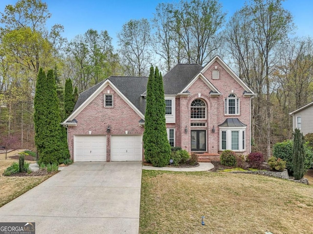 3887 Hickory Manor Dr, Suwanee, GA 30024 - view of front of house with brick siding, concrete driveway, and a front yard
