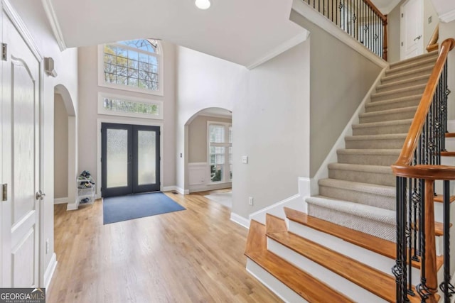 3887 Hickory Manor Dr, Suwanee, GA 30024 - foyer featuring arched walkways, french doors, healthy amount of natural light, and a towering ceiling