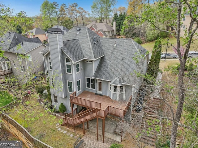 3887 Hickory Manor Dr, Suwanee, GA 30024 - rear view of house featuring a deck, roof with shingles, a chimney, and a residential view