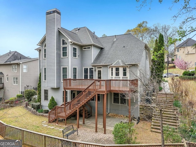 3887 Hickory Manor Dr, Suwanee, GA 30024 - back of house featuring stairway, a deck, a patio, a chimney, and roof with shingles