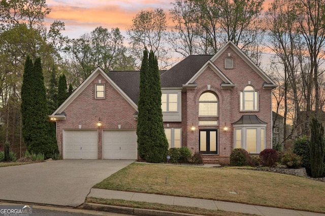 3887 Hickory Manor Dr, Suwanee, GA 30024 - traditional home with brick siding, concrete driveway, a yard, and a garage