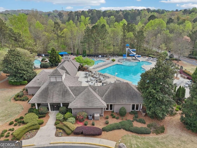 3887 Hickory Manor Dr, Suwanee, GA 30024 - aerial view of property and surrounding area featuring a pool and a heavily wooded area