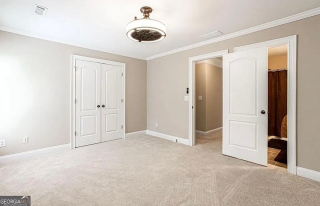 35 Inverleigh Row, Covington, GA 30014 - unfurnished bedroom featuring light colored carpet, crown molding, and a closet