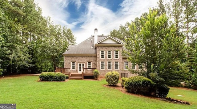 35 Inverleigh Row, Covington, GA 30014 - back of house with a lawn, brick siding, and a wooden deck