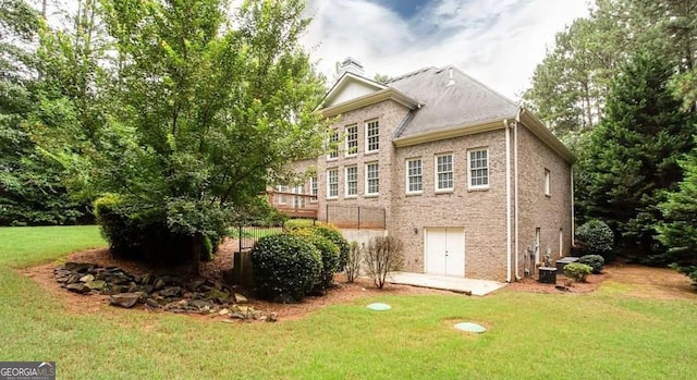 35 Inverleigh Row, Covington, GA 30014 - rear view of property featuring a yard and brick siding