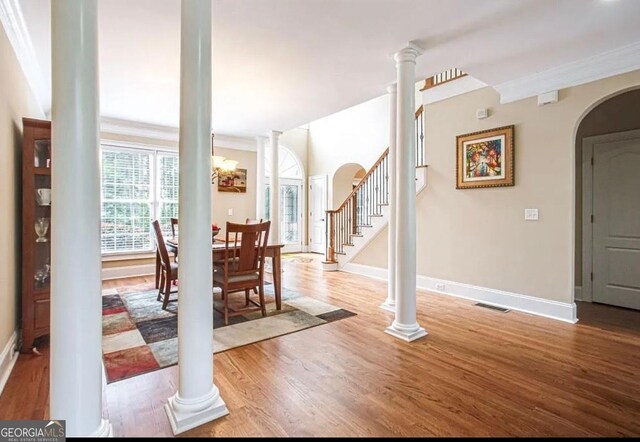 35 Inverleigh Row, Covington, GA 30014 - dining room with wood finished floors, decorative columns, crown molding, arched walkways, and stairs