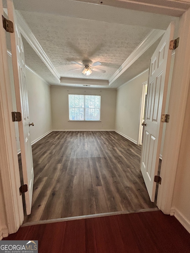 375 Sapphire Bnd, Riverdale, GA 30296 - unfurnished room featuring a tray ceiling, ornamental molding, dark wood finished floors, a ceiling fan, and a textured ceiling