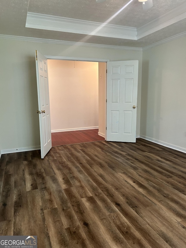 375 Sapphire Bnd, Riverdale, GA 30296 - unfurnished bedroom featuring dark wood finished floors, crown molding, a raised ceiling, and a textured ceiling