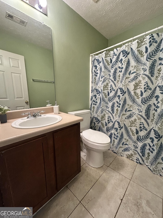 375 Sapphire Bnd, Riverdale, GA 30296 - bathroom featuring a textured ceiling, vanity, tile patterned floors, and a shower with curtain