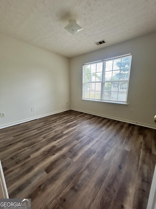 375 Sapphire Bnd, Riverdale, GA 30296 - unfurnished room with dark wood-style flooring and a textured ceiling