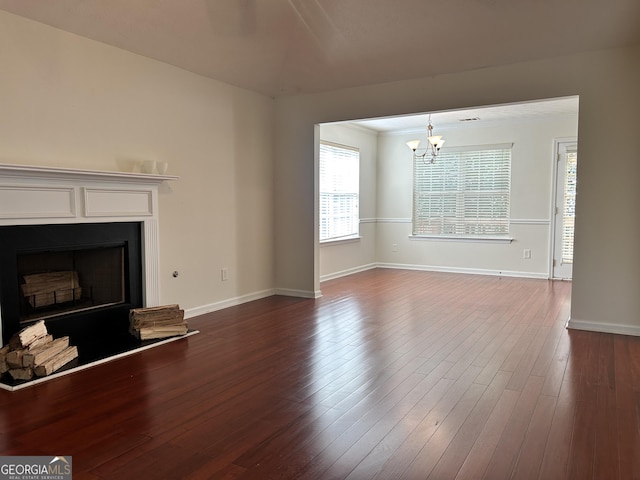 375 Sapphire Bnd, Riverdale, GA 30296 - unfurnished living room with a chandelier, a fireplace, and dark wood-type flooring