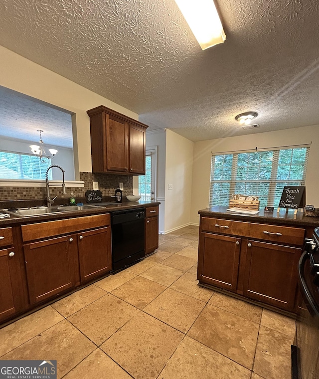 375 Sapphire Bnd, Riverdale, GA 30296 - kitchen with black dishwasher, dark countertops, decorative backsplash, a textured ceiling, and a chandelier