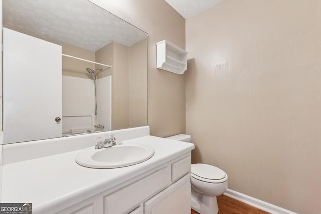 3450 Saddleton Way, Douglasville, GA 30134 - bathroom featuring vanity, wood finished floors, a textured ceiling, and a shower