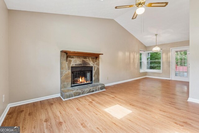 3450 Saddleton Way, Douglasville, GA 30134 - unfurnished living room with wood finished floors, ceiling fan, a stone fireplace, and lofted ceiling